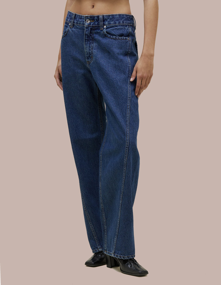 Mid-rise Eckhaus Latta pant in lightly washed 14oz cotton denim. Designed with a bowed leg and twisted side seams. Finished with signature EL back pockets.
