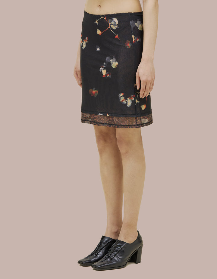 Eckhaus Latta slim fitting slip skirt with picot edge at waistband. Made of double layer digitally printed micromesh. Each layer has a distinct all over print, with the bottom layer peeking out from the hem of the top layer.