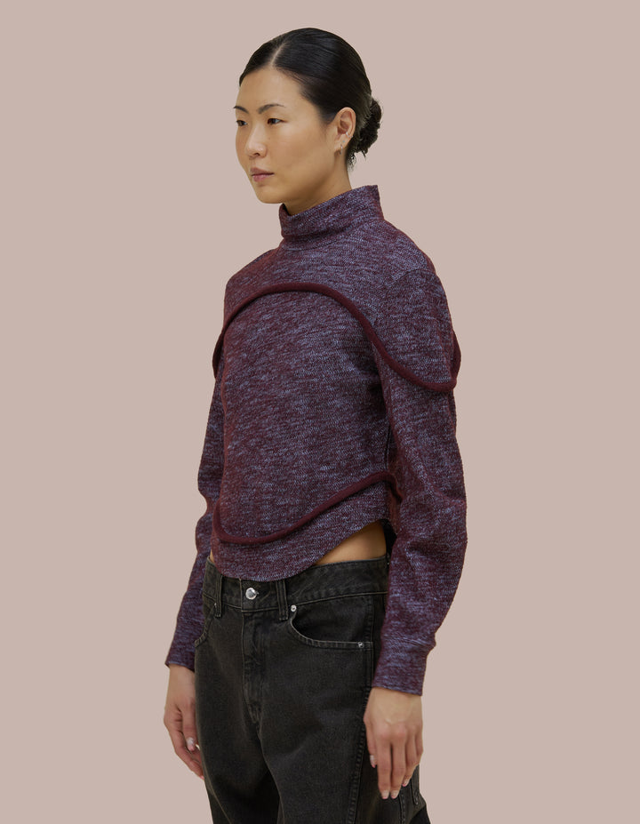 A structured fit Eckhaus Latta turtleneck with subtle tailoring details and bound curvilinear seams creating definition as they move across your body. Made from a boiled wool cotton blend.