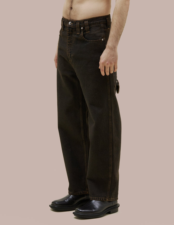 Our classic Eckhaus Latta baggy jean in 14oz 100% cotton indigo denim, tinted in marigold then stonewashed for a vintage look. Features a screenprint on the back right pocket, hammer loop at the back left, and signature EL back pockets.