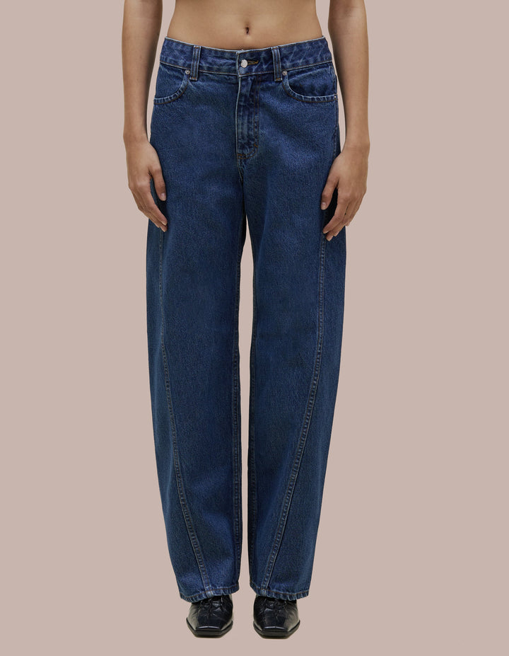 Mid-rise Eckhaus Latta pant in lightly washed 14oz cotton denim. Designed with a bowed leg and twisted side seams. Finished with signature EL back pockets.