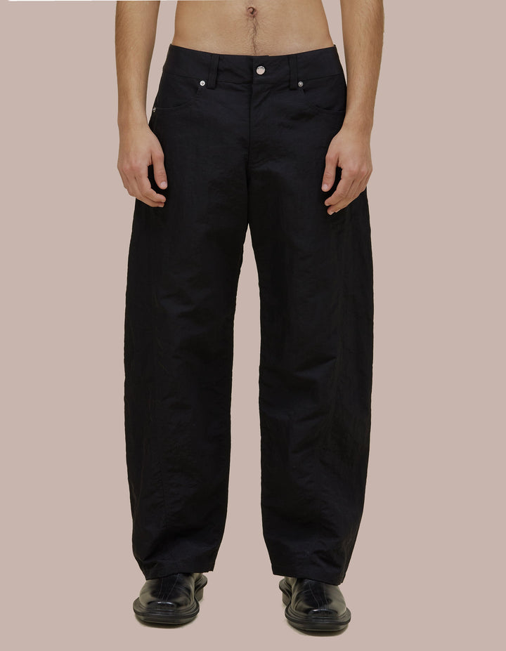 Mid-rise Eckhaus Latta pant in Italian nylon with a bowed leg and twisted side seams for subtle shape. Finished with signature EL back pockets.
