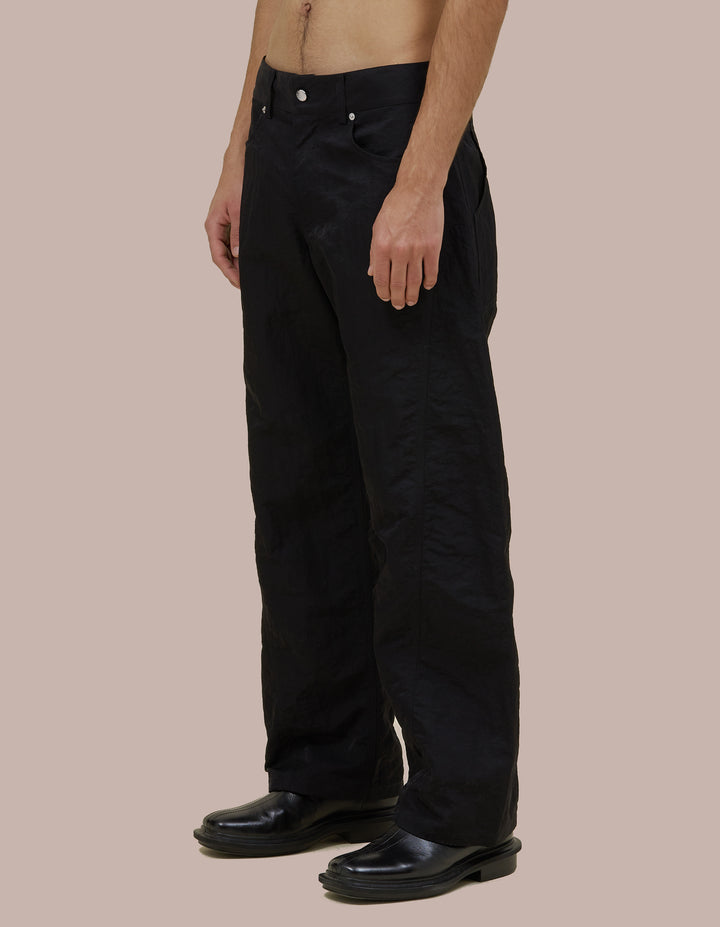 Mid-rise Eckhaus Latta pant in Italian nylon with a bowed leg and twisted side seams for subtle shape. Finished with signature EL back pockets.
