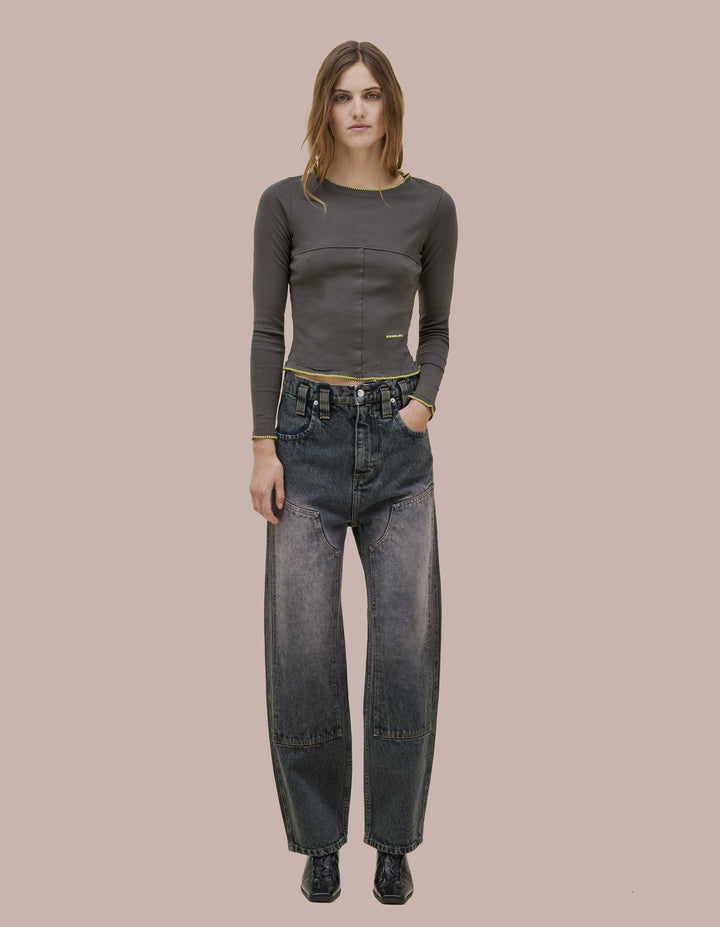 Our classic Eckhaus Latta baggy jean in 14oz 100% cotton indigo denim, overdyed a warm gray and mineral washed with natural fading at the knee patches. Features a double knee, hammer loop at the back left pocket, and signature EL back pockets.