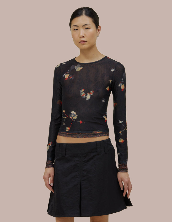 Eckhaus Latta slim fit, long sleeve crew neck. Made of double layer digitally printed micromesh. Each layer has a distinct all over print, with the bottom layer peeking out from the hem of the top layer.