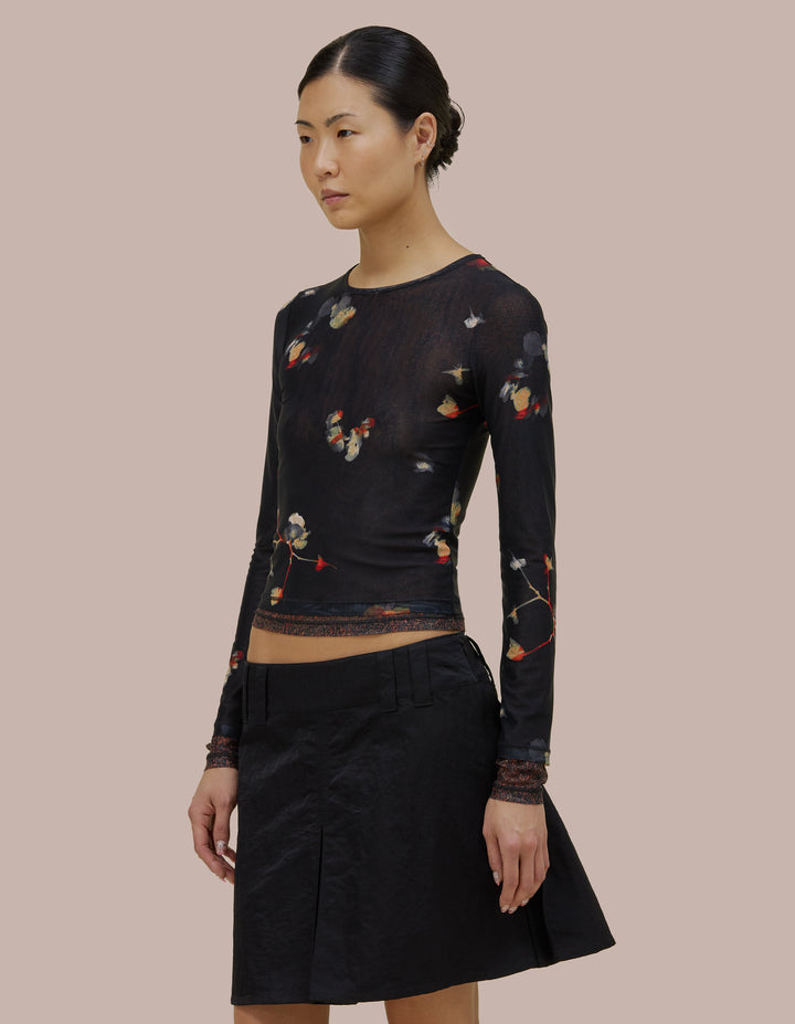 Eckhaus Latta slim fit, long sleeve crew neck. Made of double layer digitally printed micromesh. Each layer has a distinct all over print, with the bottom layer peeking out from the hem of the top layer. 