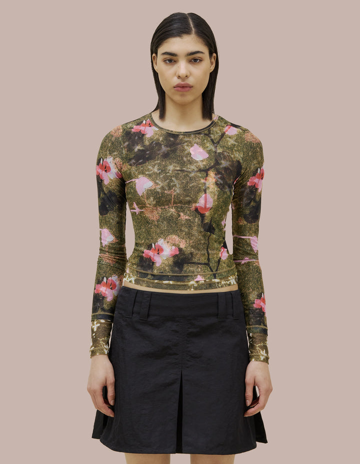 Eckhaus Latta slim fit, long sleeve crew neck. Made of double layer digitally printed micromesh. Each layer has a distinct all over print, with the bottom layer peeking out from the hem of the top layer. 