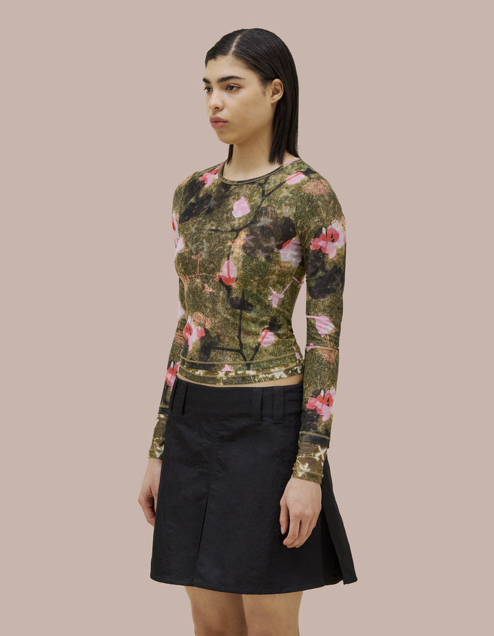 Eckhaus Latta slim fit, long sleeve crew neck. Made of double layer digitally printed micromesh. Each layer has a distinct all over print, with the bottom layer peeking out from the hem of the top layer. 