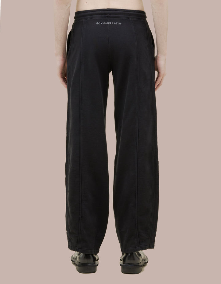 Mid-rise Eckhaus Latta sweatpants in a brushed french terry with a wide-leg. Garment dyed in solid black, finished with a glossy black ""Eckhaus Latta"" logo on the rear.