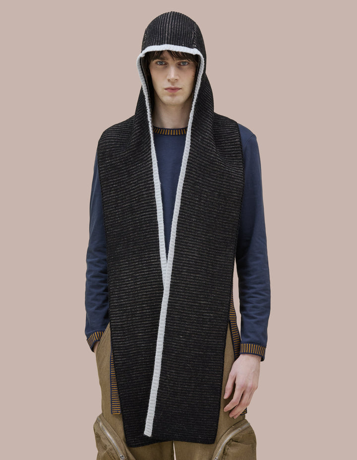 A double knit merino wool scarf combined with a bonnet to frame the face. 