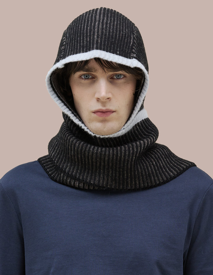 A double knit merino wool scarf combined with a bonnet to frame the face. 