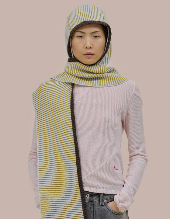 A double knit merino wool scarf combined with a bonnet to frame the face. 