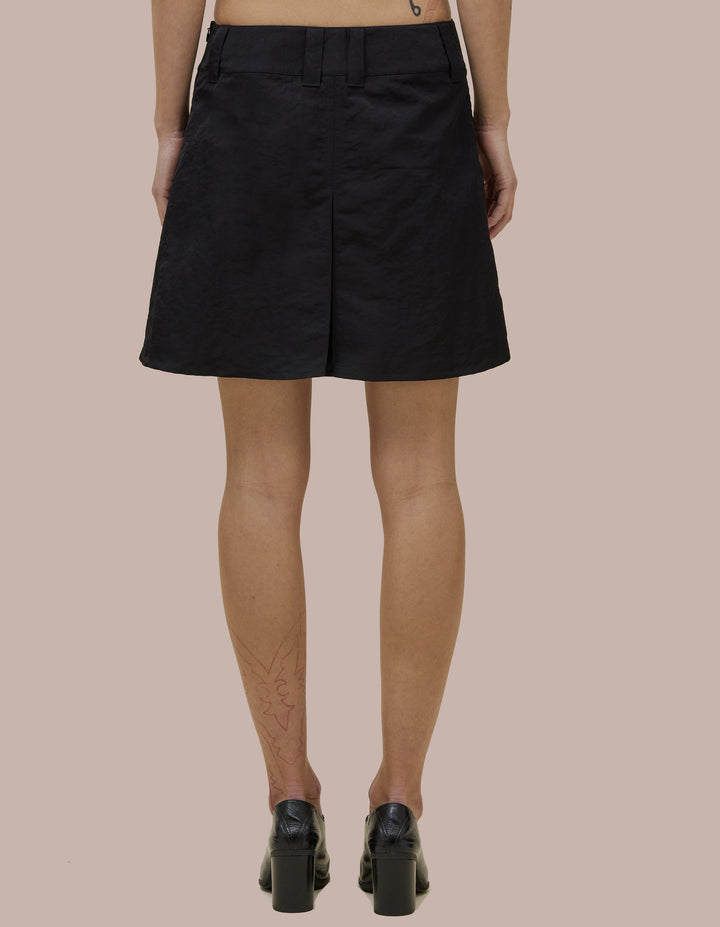 Low-rise miniskirt in Italian nylon with kick pleats for a flared silhouette. Finished with an invisible zip at the side seam.