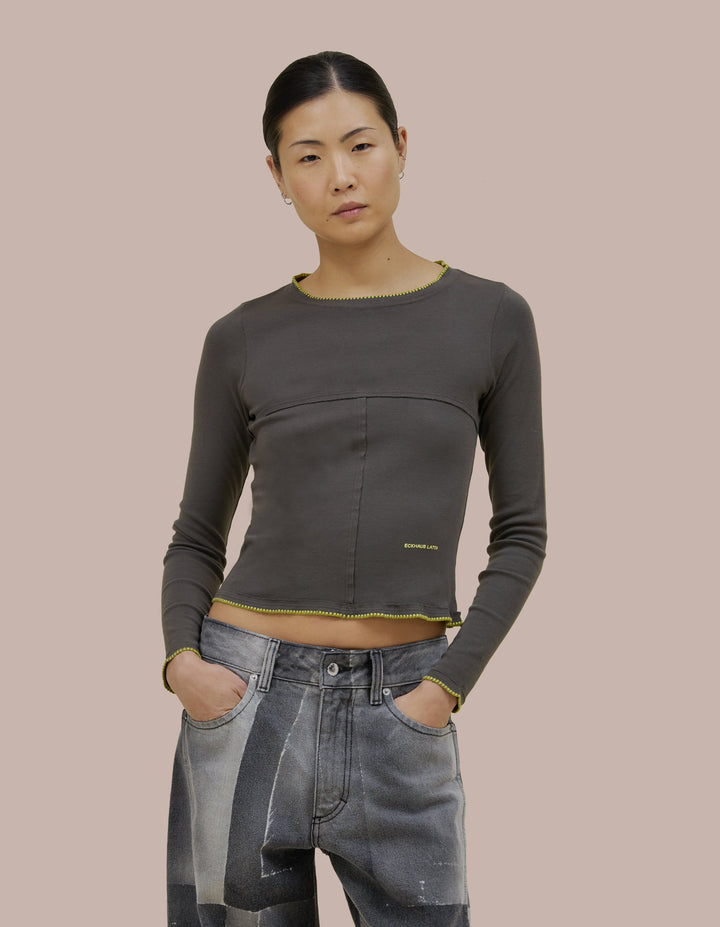 Our classic Eckhaus Latta lapped baby crewneck in a 1x1 cotton baby rib. Fitted, slightly cropped. Topstitched raw edged seams create form-flattering vertical and horizontal lines across the body.