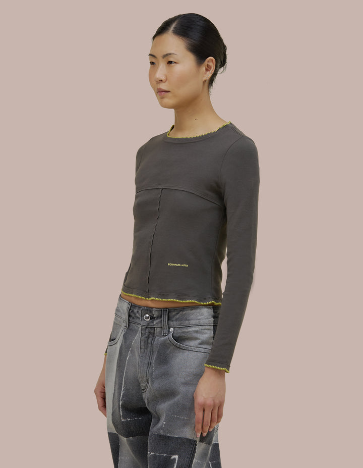 Our classic Eckhaus Latta lapped baby crewneck in a 1x1 cotton baby rib. Fitted, slightly cropped. Topstitched raw edged seams create form-flattering vertical and horizontal lines across the body.
