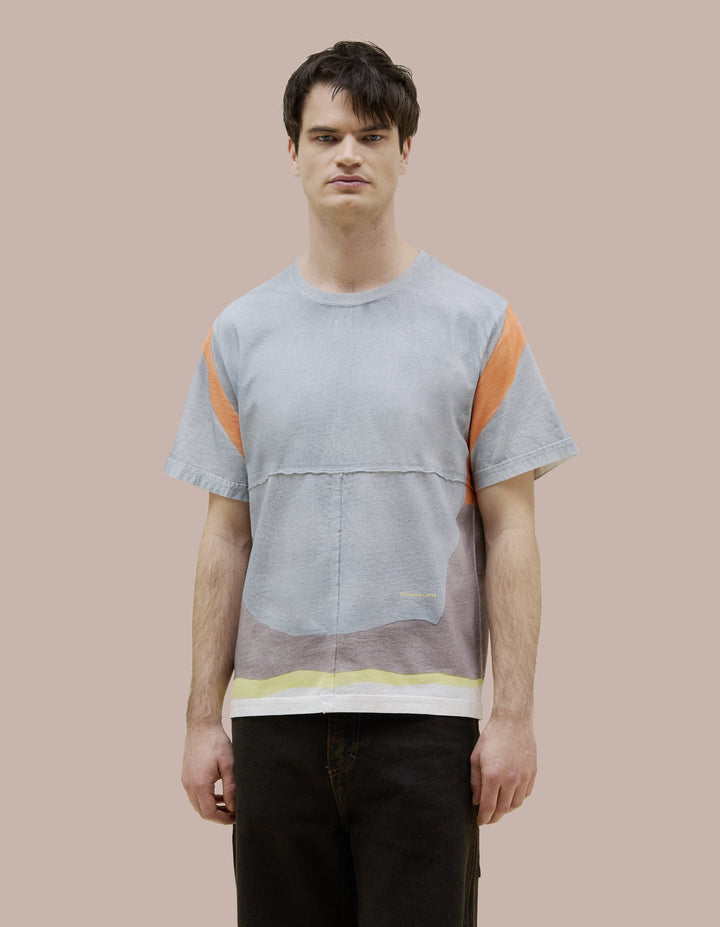 Our classic Eckhaus Latta fit tee in soft Pima cotton jersey with lapped raw-edged seams. Features an all-over speckled spray design, highlighted by vibrant orange shoulder straps and a yellow hem. Finished with a yellow "Eckhaus Latta" logo on the abdomen.