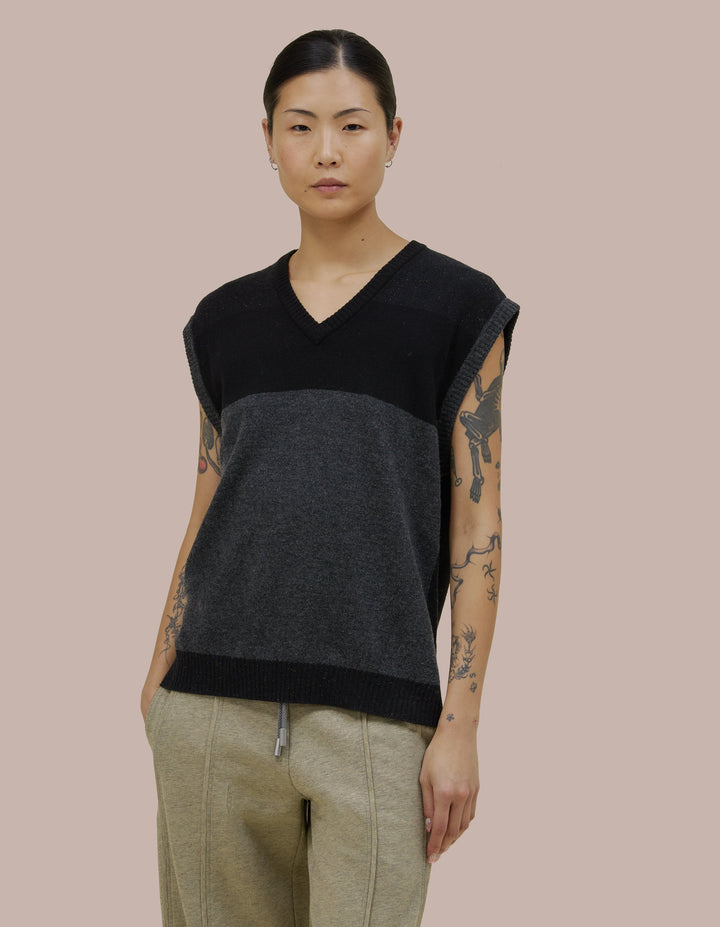 V neck Eckhaus Lata vest with a boxy, oversized fit. Features donegal speckled details throughout the yarn with coloblocking throughout. 
