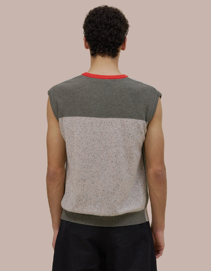 V neck Eckhaus Lata vest with a boxy, oversized fit. Features donegal speckled details throughout the yarn with coloblocking throughout. 
