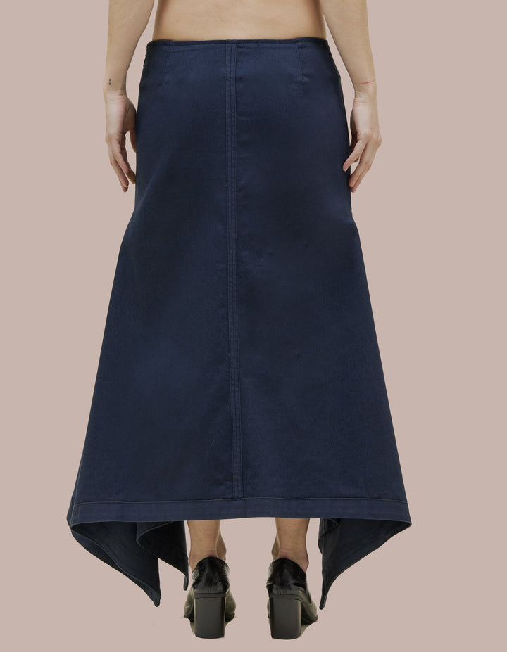 Mid-rise skirt in 9oz Japanese denim with an exaggerated handkerchief hem that opens at the side seam. Features an invisible zipper and contrast facing and seam details.
