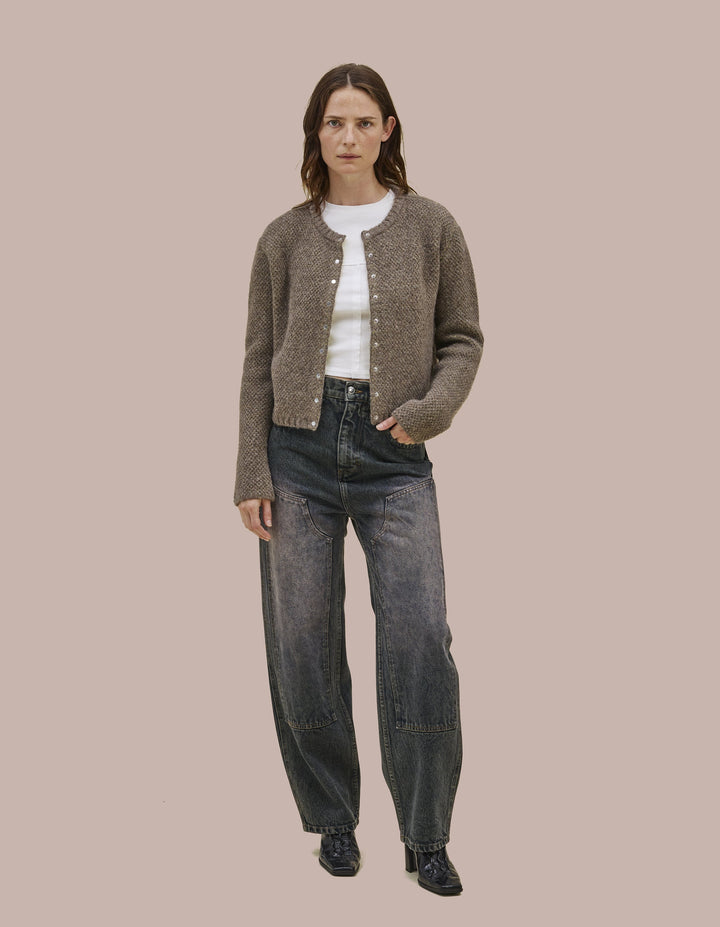 Snap front cardigan constructed from doublefaced knit. Has a boxy fit that hangs off the body. 