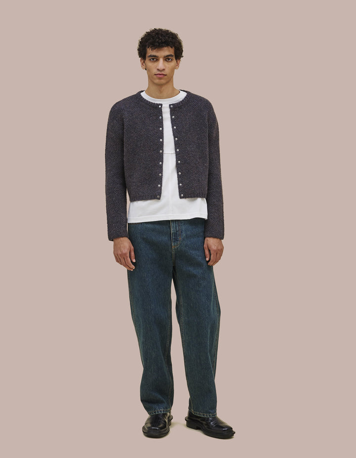 Snap front cardigan constructed from doublefaced knit. Has a boxy fit that hangs off the body. 